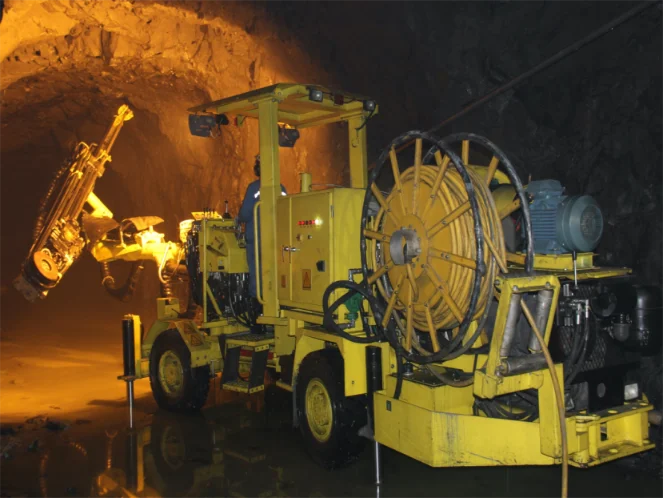 Trackless mining equipment in an underground mine tunnel.