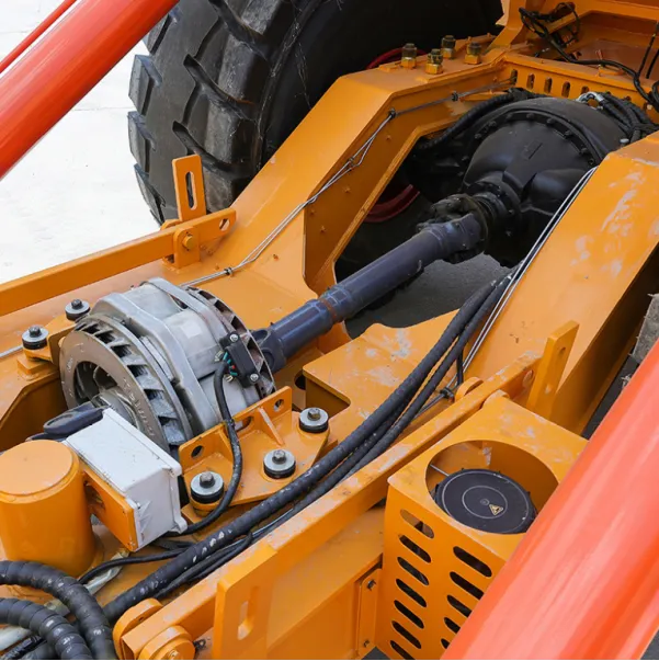 Close-up of the drivetrain and motor components on an orange heavy machine