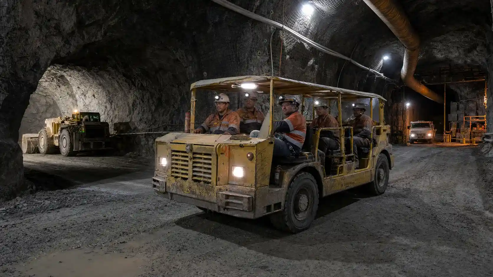 Underground mining utility vehicles supporting crew transport, maintenance and concrete work in a hard-rock mine